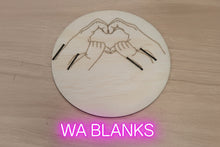 Load image into Gallery viewer, Wooden cutout of hands forming a heart shape on a wooden surface
